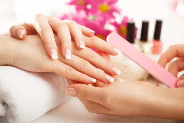 A woman getting her nails painted white