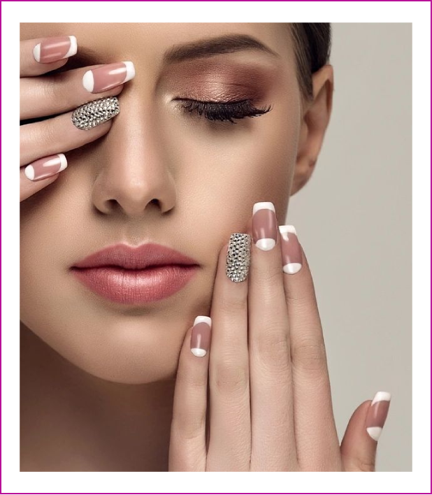 A woman with long nails and silver nail art.